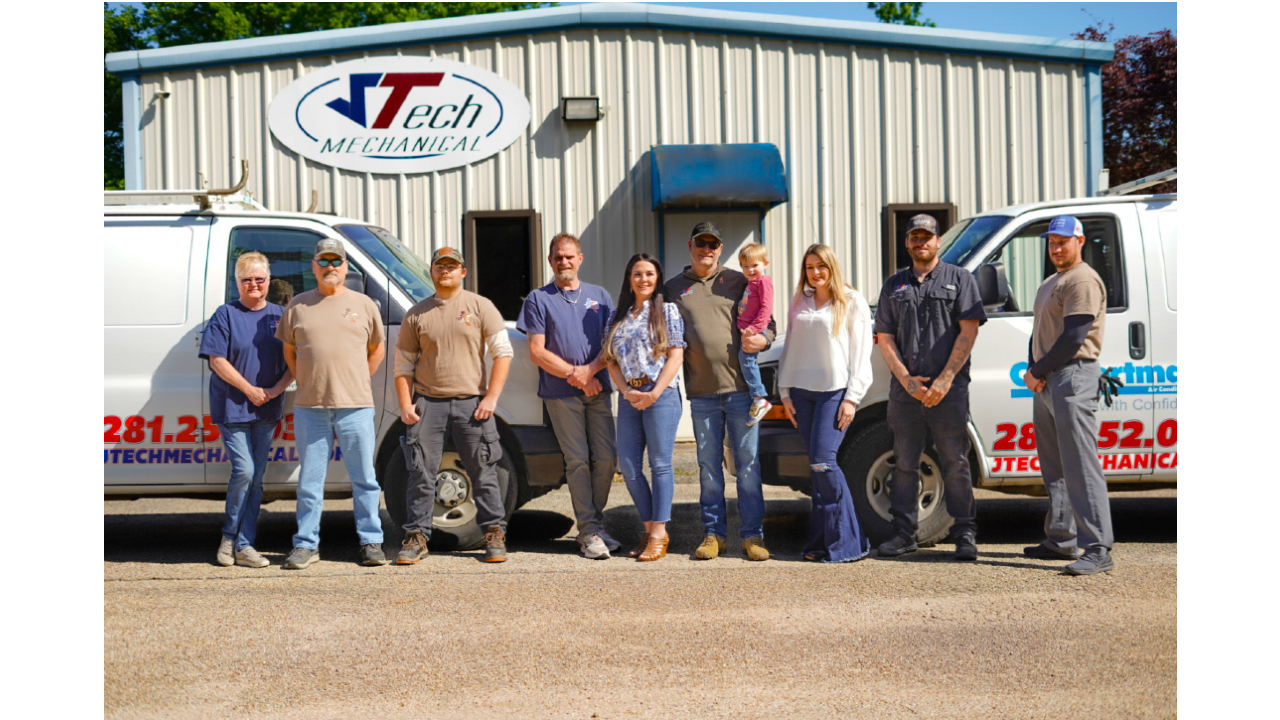 Group of staff memebers from JTech Mechanical standing in from of their metal shop building